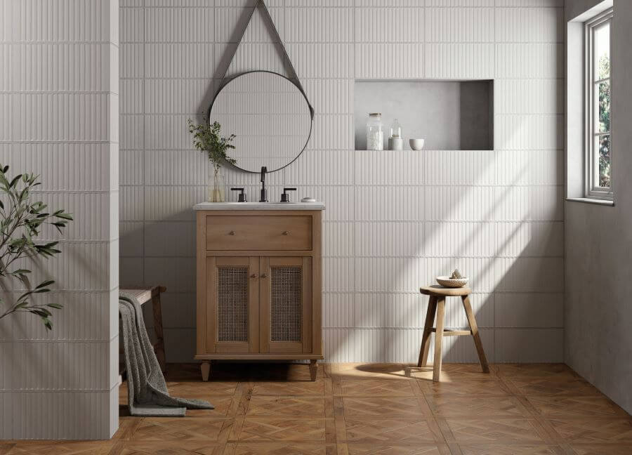 TANGLE-RUSTIC-WOOD-CERAMIC-TILE-BATHROOM. Image shows wood effect tile on floor of bathroom with white tiles on walls and vanity basin with mirror