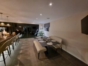 Lava. Image shows dark brown tile in kitchen with bench seating and dining table