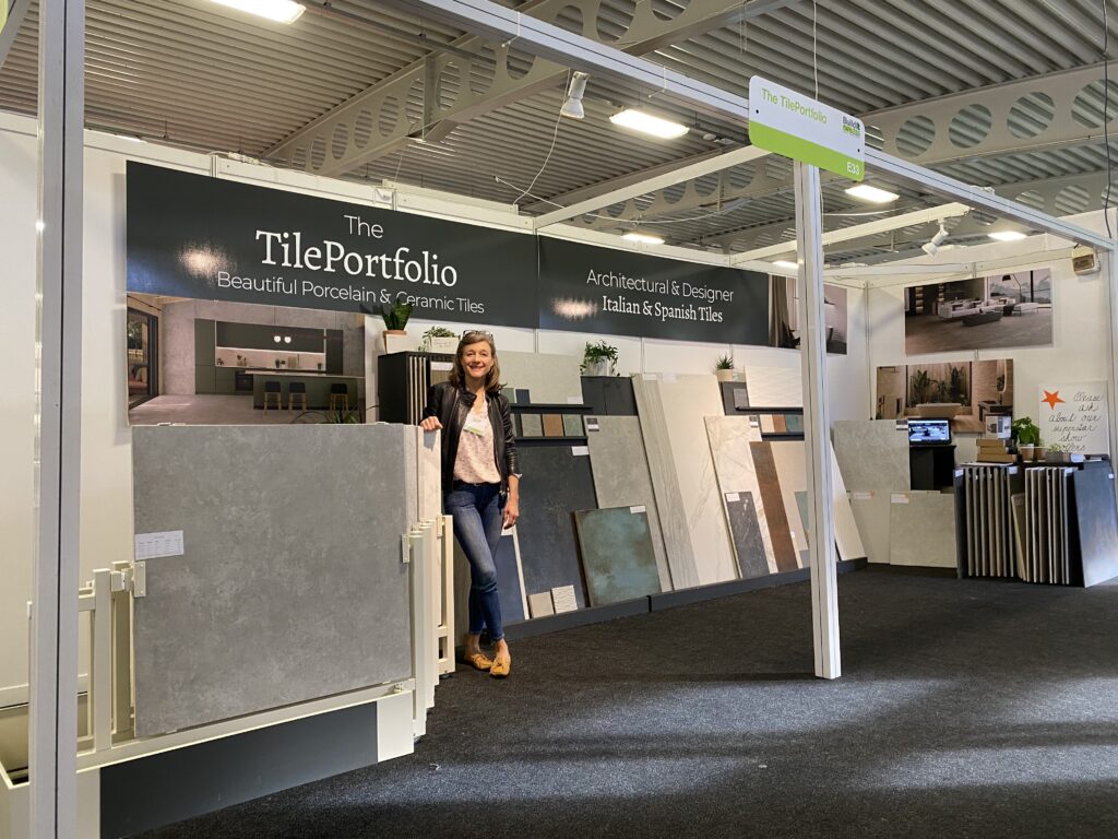 KENT-EXHIBITION. Image shows lady on exhibition stand with tiles on stands