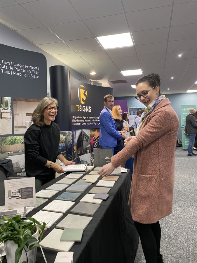 chamber. Image shows to people discussing tiles at an exhibition