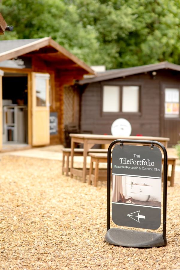 SHOWROOM. Image shows signage outside with The TilePortfolio logo and an arrow