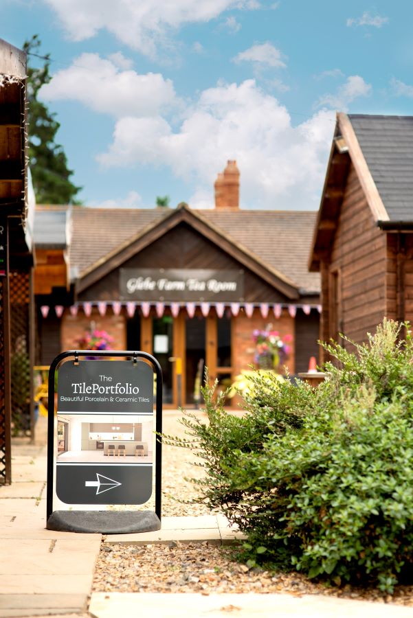 SHOWROOM. Image shows signage outside with The TilePortfolio logo and an arrow