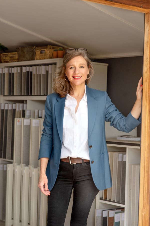 SHOWROOM. Image shows lady at door of a tile showroom smiling