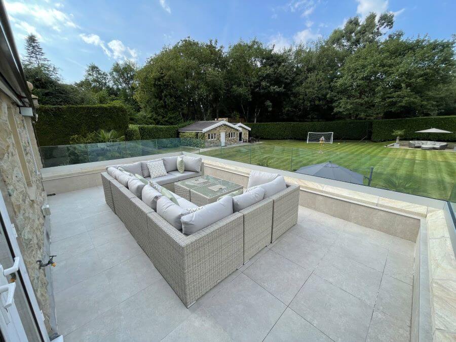 DOCKLANDS-BEIGE-ROOF. Image shows tiles on a roof terrace with dining suite and overlooking lawn