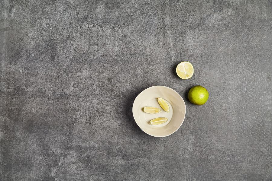 BEAT-ANTHRACITE-CEMENT-LOOK-PORCELAIN-TILE-CLOSEUP. Image shows close up of anthracite tile with some limes