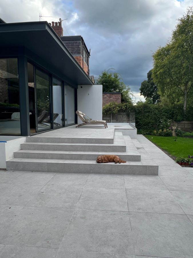 METRO-SILVER. Image shows silver tiles to patio in garden and steps with dog