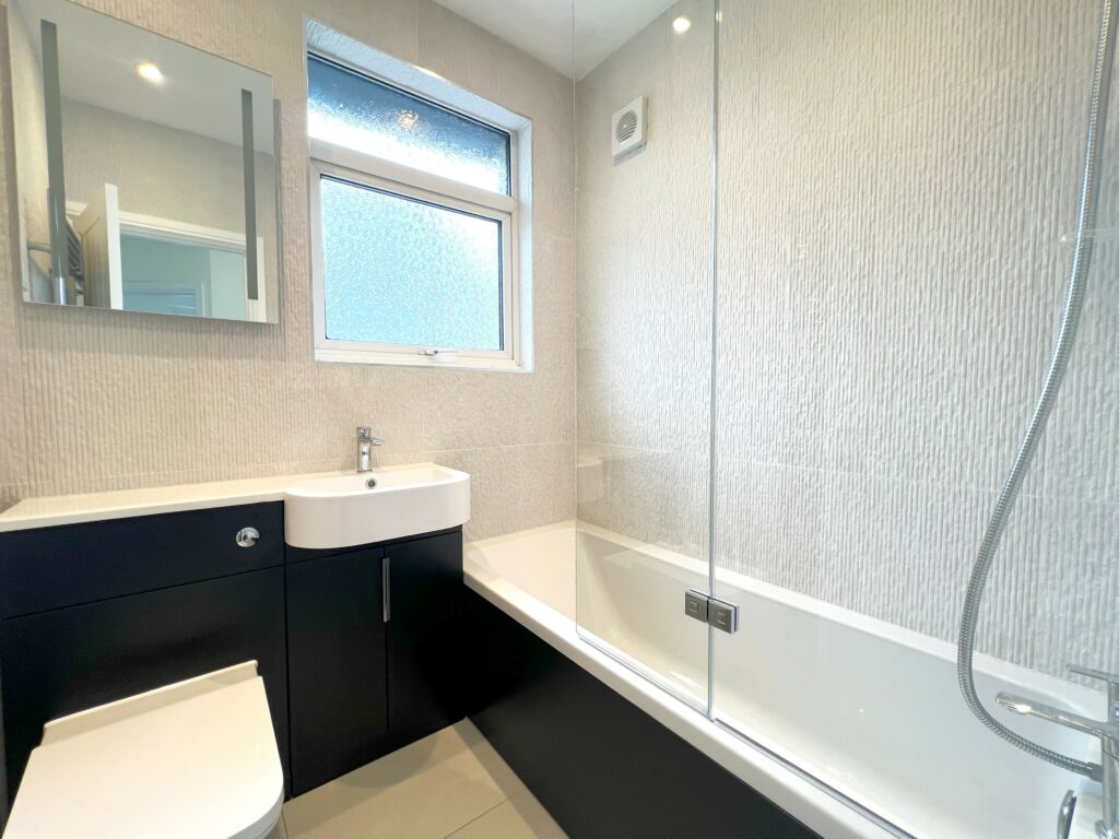 DOCKLANDS-TEXTURED-WALL-TILES. Image shows bathroom with textured wall tiles around walls of room