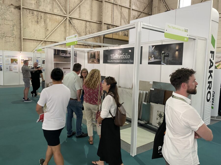 BICESTER-EXHIBITION. Image shows people on exhibition stand talking with tiles in the background