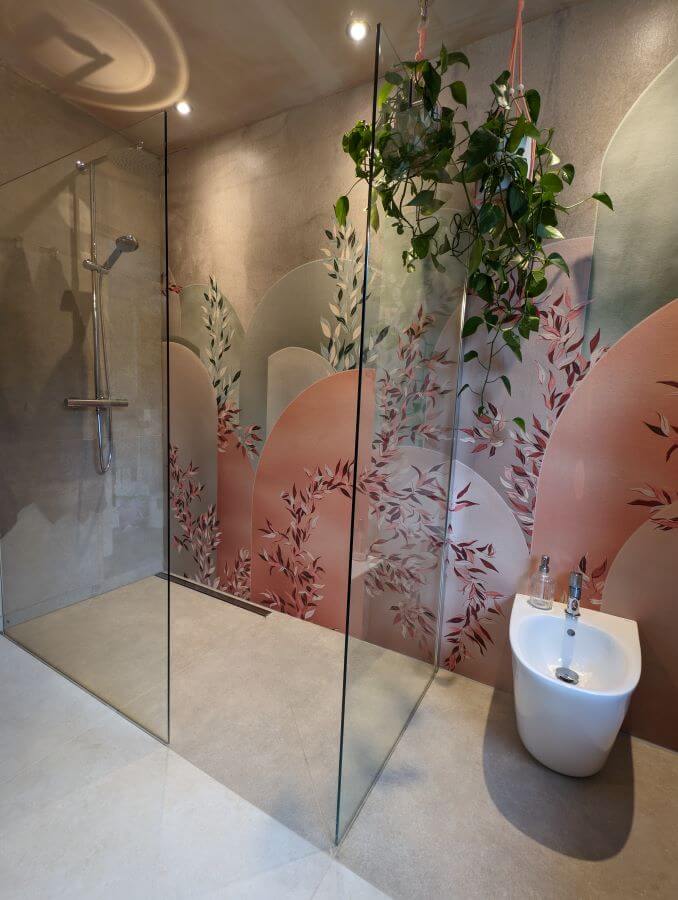 A-ROOM-IN-THE-GARDEN. Image shows floral waterproof wall paper in shower area with cream and beige tiles to floor