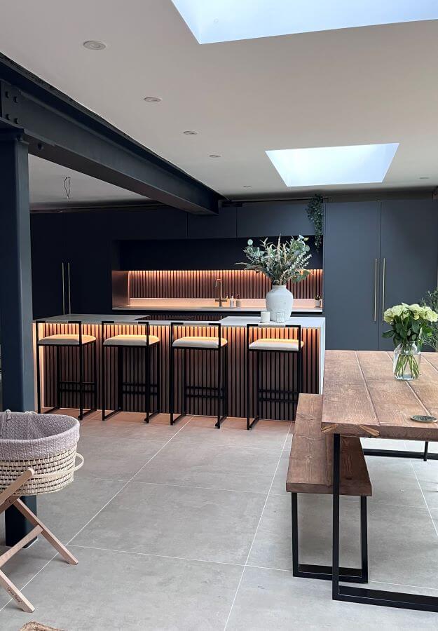 BEAT-BEIGE-KITCHEN. Image shows beige tile to floor of modern kitchen with wooden seating to the right and blue kitchen to the rear