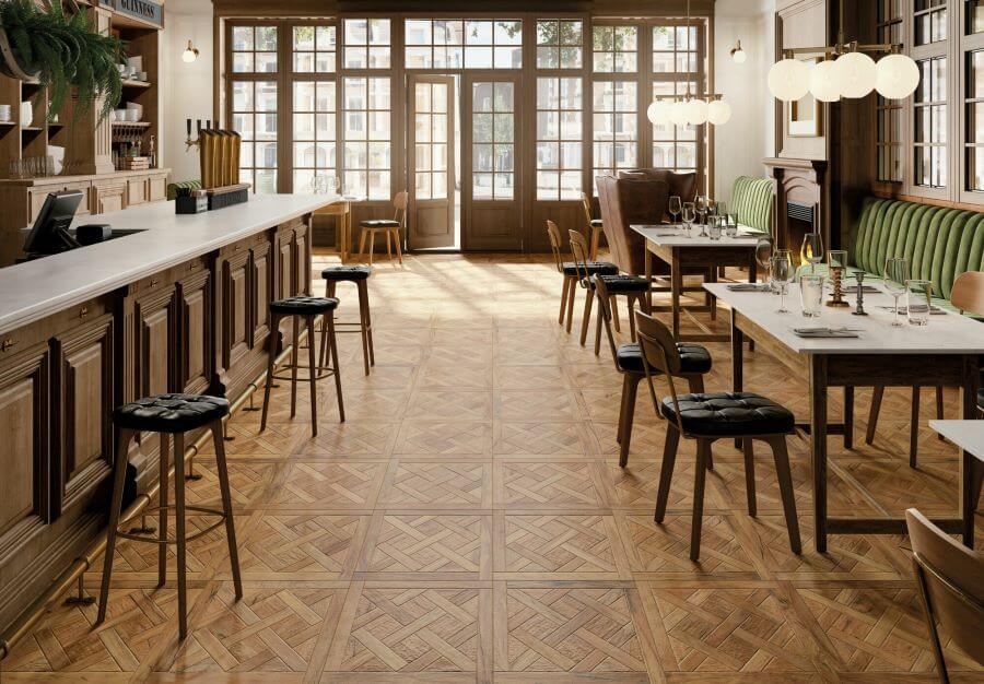 TANGLE-RUSTIC-WOOD-CERAMIC-TILE. Image shows rustic wood ceramic tile in restaurant with a bar and tables and chairs