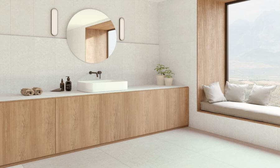 Abode White. Image shows white limestone porcelain tile in bathroom with window seat