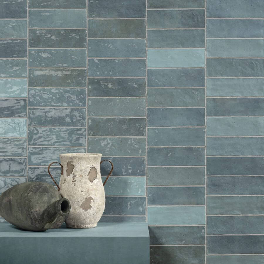 ADORE-AQUA-CERAMIC-SPANISH-TILE. Image shows blue ceramic Spanish tile on wall with vases in front