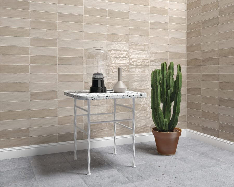 ADORE_SAND_CERAMIC_SPANISH_TILE. Image shows cream ceramic Spanish tile on two walls with cactus plant and a table