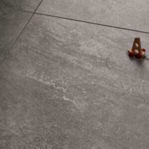 ALPINE-SCORCH-QUARTZ-EFFECT-PORCELAIN-TILE. Image shows brown quartz effect porcelain tile swatch with toys