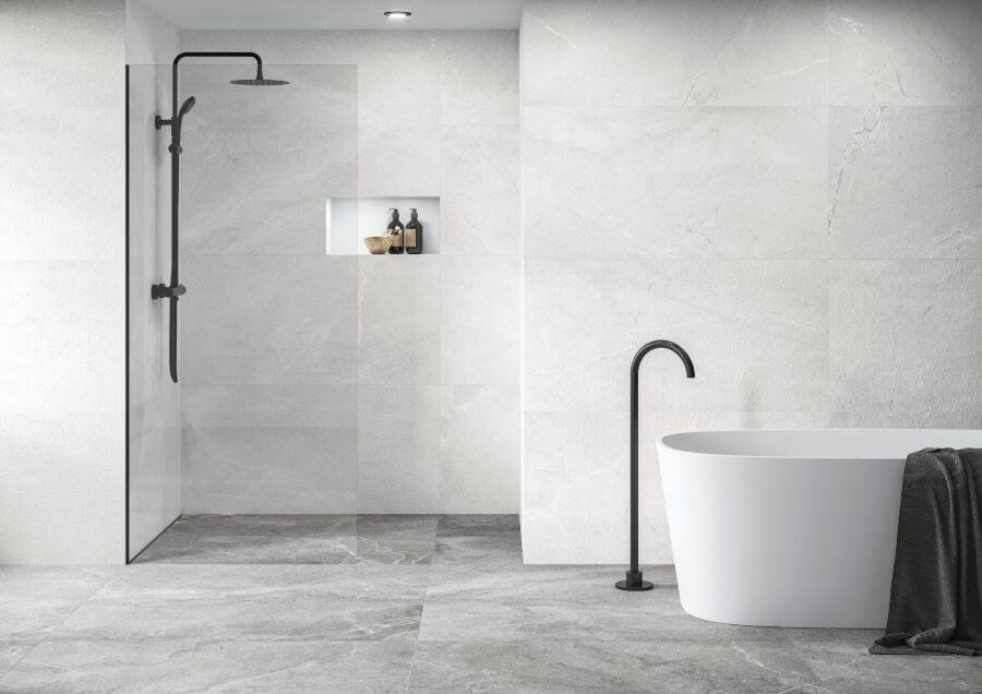 Bliss White. Image shows white porcelain large stone tiles on bathroom walls with bath and shower