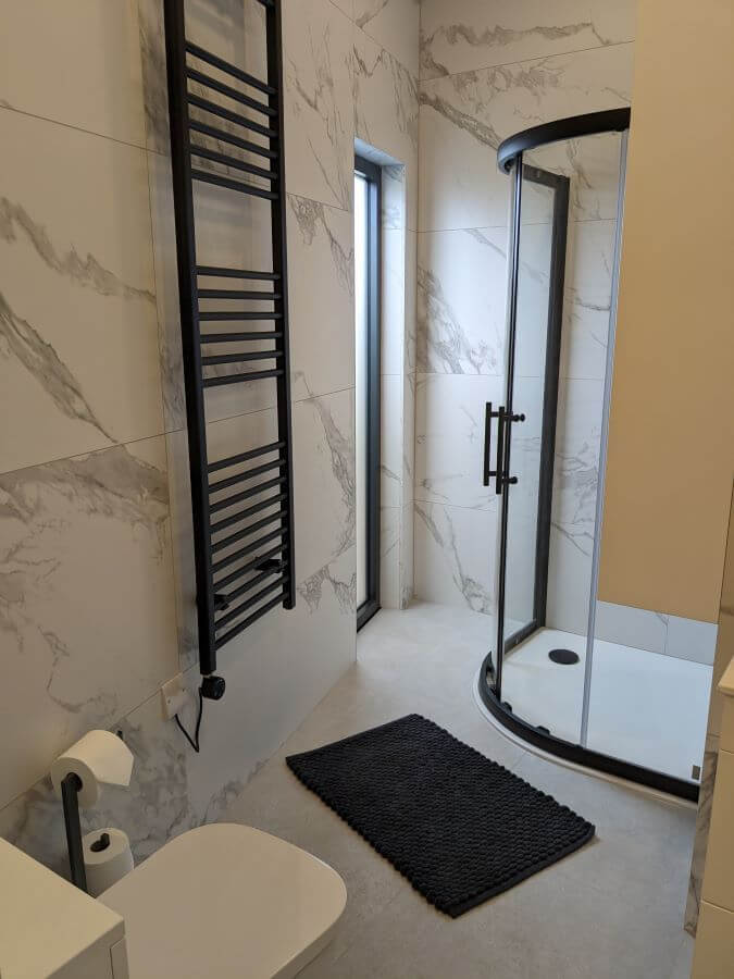 Carerra Argent. Image shows white tile with light grey veins in bathroom setting