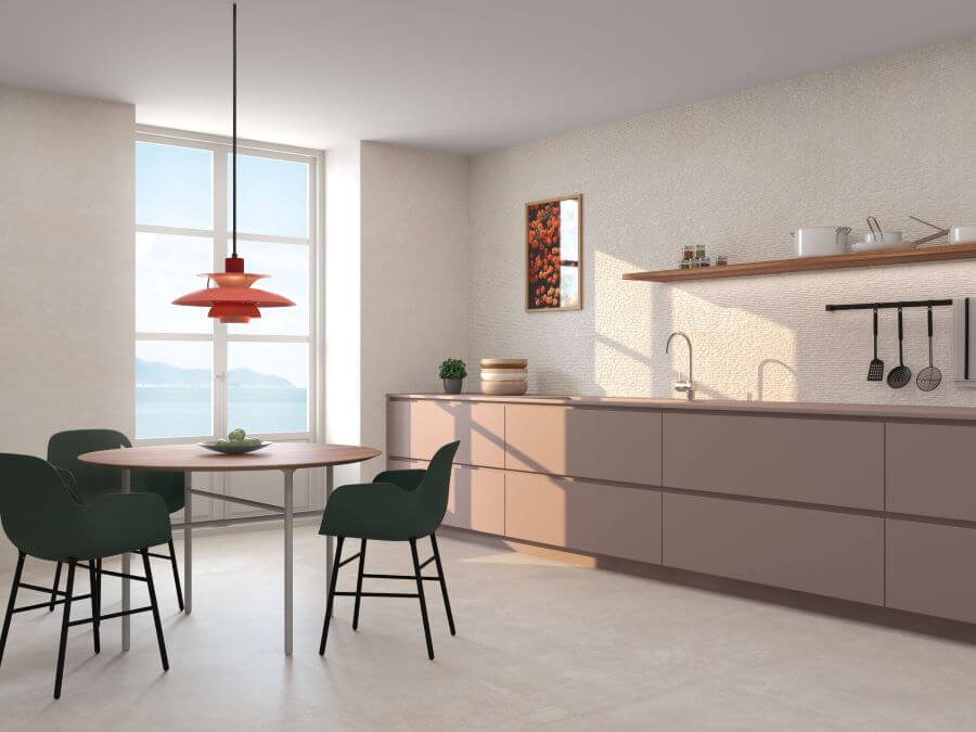 DOCKLANDS-BEIGE-CEMENT-PORCELAIN-TILE. Image shows beige cement porcelain tile in kitchen with table and green chairs