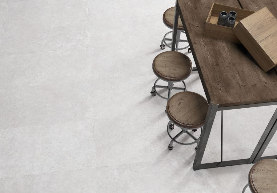 DOCKLANDS-WHITE-CEMENT-PORCELAIN-TILE. Image shows white cement porcelain tile on kitchen floor with wooden table and stools