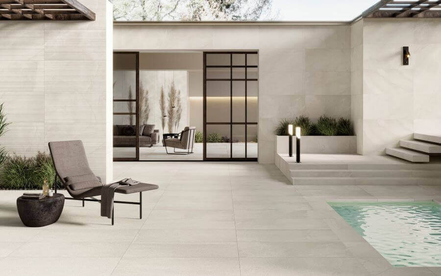 Ethos Shore. Image shows cream stone look porcelain tile around a pool