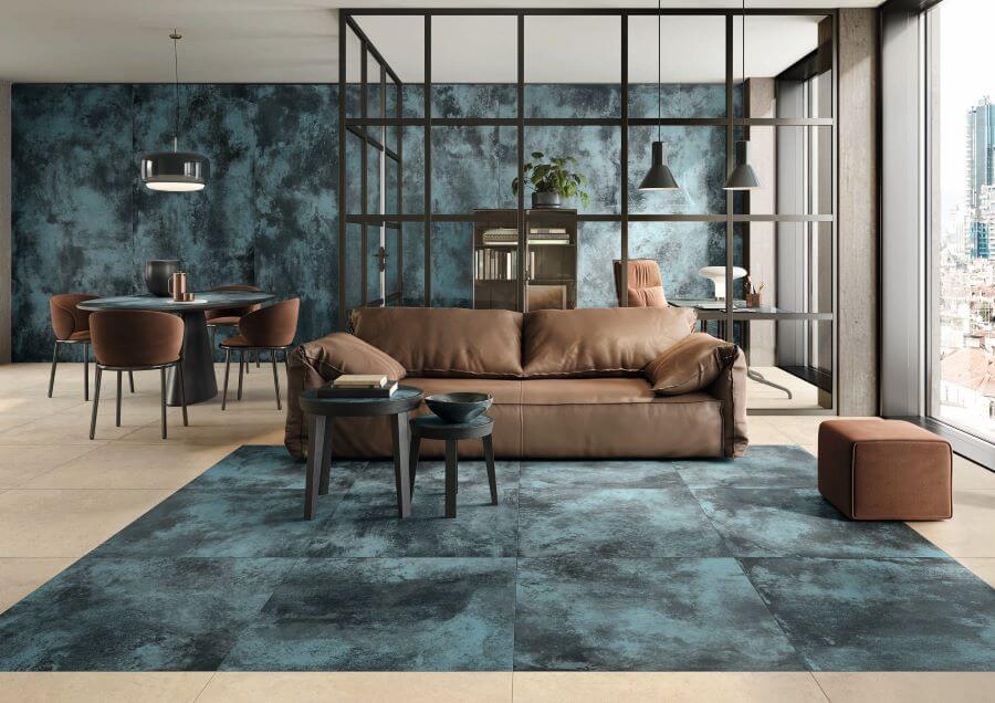 FORGE-BLUE-MOTTLE-PORCELAIN-METALLIC-TILES-FLOOR. Image shows blue metallic tiles in lounge on floor with brown sofa and office in the background