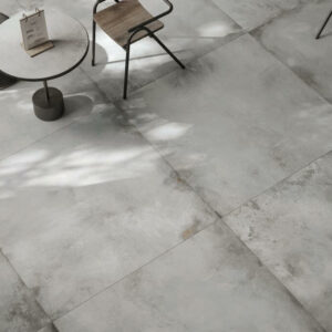 Forge Titanium. Image shows white porcelain metallic tiles in cafe with table and chair