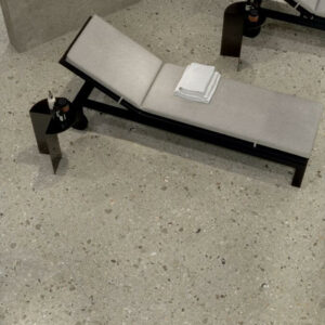 FUSION-COLD-TERRAZZO-PORCELAIN-TILES. Image shows terrazzo porcelain tiles in spa on floor with loungers