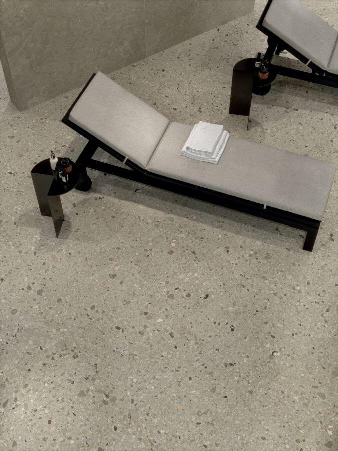 FUSION-COLD-TERRAZZO-PORCELAIN-TILES. Image shows terrazzo porcelain tiles in spa on floor with loungers