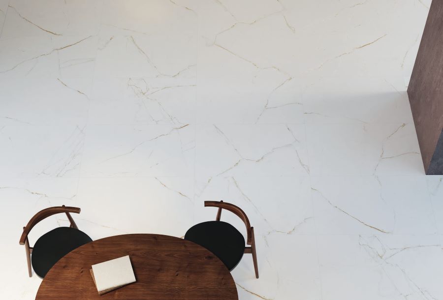 Jewel. Image shows white marble effect porcelain tile with nutmeg veins with table and chairs