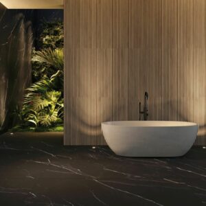 OAKWOOD-WOOD-LOOK-WALL-TILE-HONEY-PECAN. Image shows honey and pecan striped oakwood look wall tile on wall with bath and foliage to rear