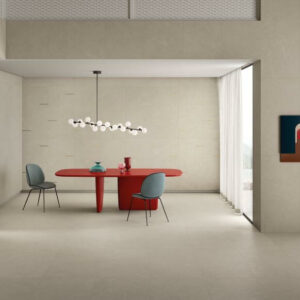 POISE-IVORY-STONE-LOOK-PORCELAIN-TILES. Image shows ivory stone look porcelain tiles in open plan dining area with red table