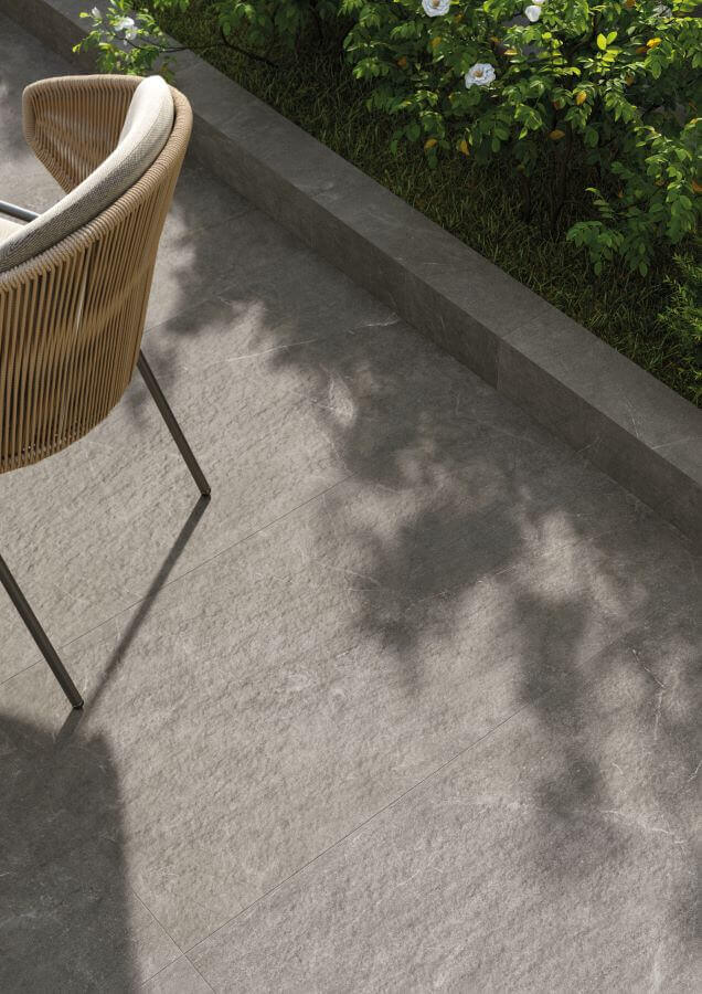 POISE-SILVER-2CM-OUTSIDE-PORCELAIN-TILES. Image shows silver 2cm tiles outside on patio