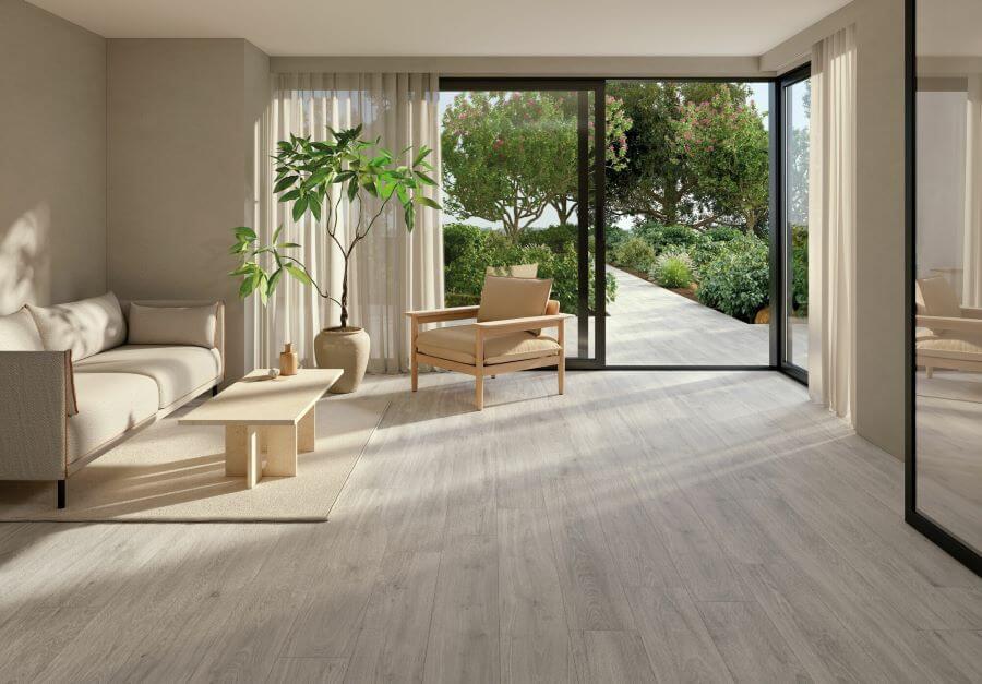 SERENITY-ASH-WOOD-PLANK-PORCELAIN-TILE. Image shows ash wood plank porcelain tile in lounge and outside