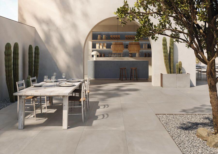 TONE-CONCRETE-2CM-OUTSIDE-PORCELAIN-PAVER. Image shows light brown concrete 2cm outside porcelain paver with external bar, kitchen and seating