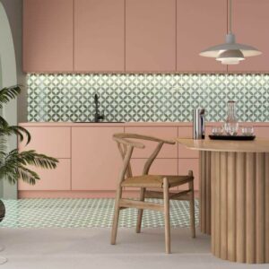 BLOOM-GREEN-PORCELAIN-FEATURE-TILES-KITCHEN. Image shows green and white porcelain feature tiles in kitchen with pink kitchen cabinetry and wooden table and chairs