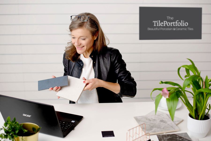 JO-AT-DESK. Image shows lady at desk showing customers tiles via laptop