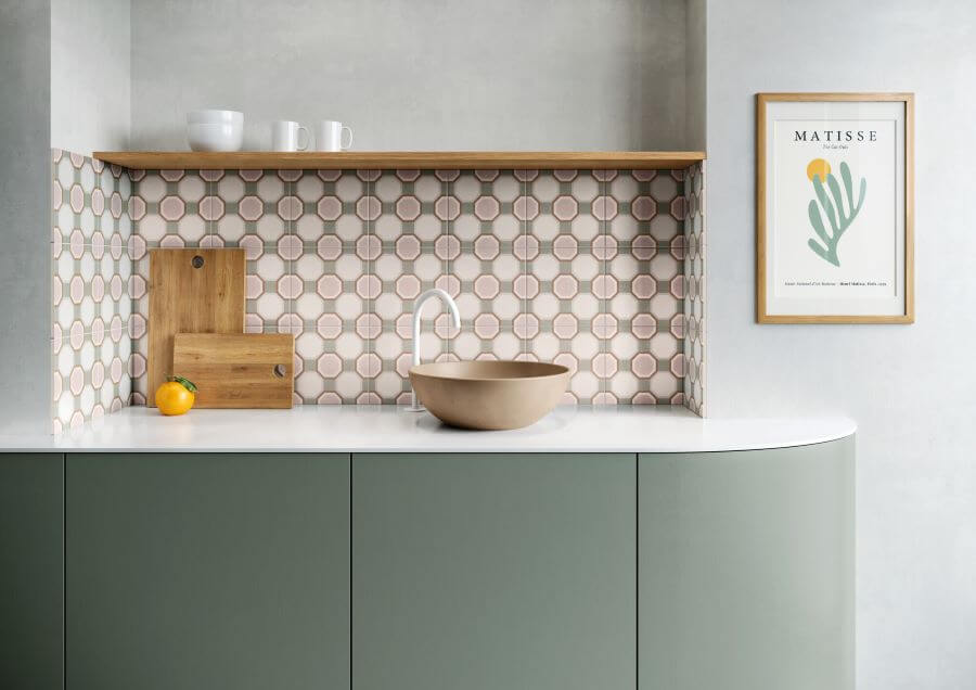 MOTIF-PATTERNED-WALL-TILE-PINK-GEO. Image shows pink and grey patterned wall tile as a kitchen splashback with sage green cabinerty