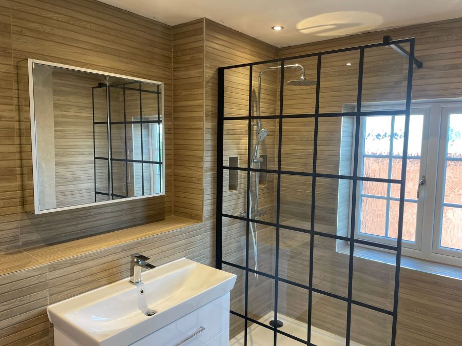 SEASON-CARAMEL. Image shows wood effect tiles in shower