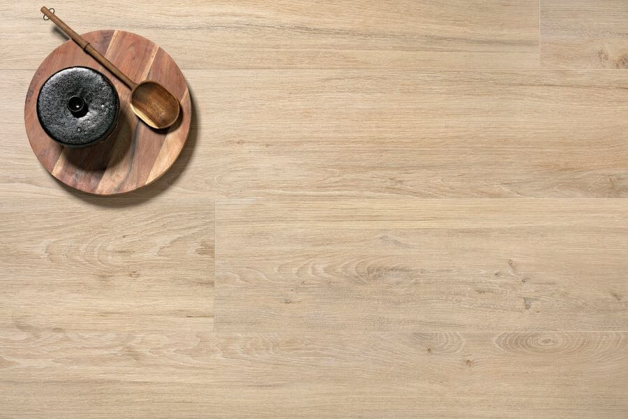 SERENITY-MAPLE-WOOD-PLANK-PORCELAIN-TILE. Image shows maple wood plank porcelain tile with plate and spoon