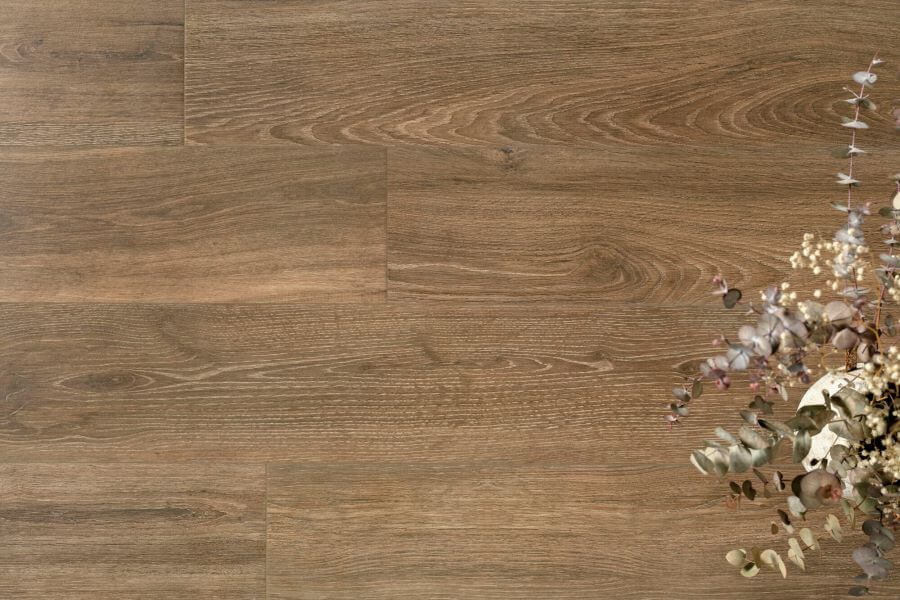 SERENITY-SIENNA-WOOD-PLANK-PORCELAIN-TILE. Image shows dark wood plank porcelain tile with flowers