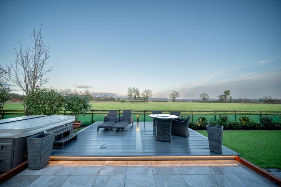 WILLOWS-1. Image shows patio with porcelain tiles leading to a seating area with a jacuzzi