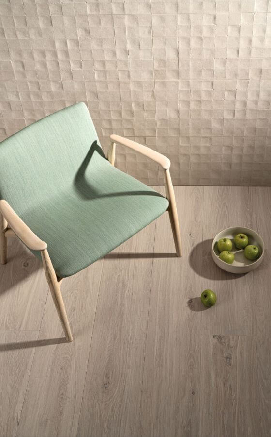 Image shows oak wooden effect tiles with chair and bowl of apples