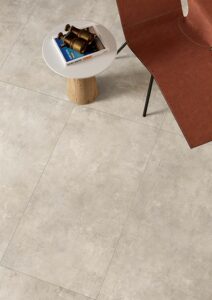 Image shows Minima porcelain concrete look tile in mist to wall with shelf and books