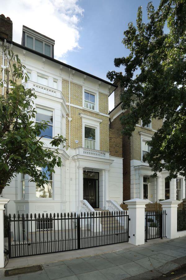 ITALIAN-INSIDE-OUTSIDE-PORCELAIN-TILES-3. Image shows street view of grand property.