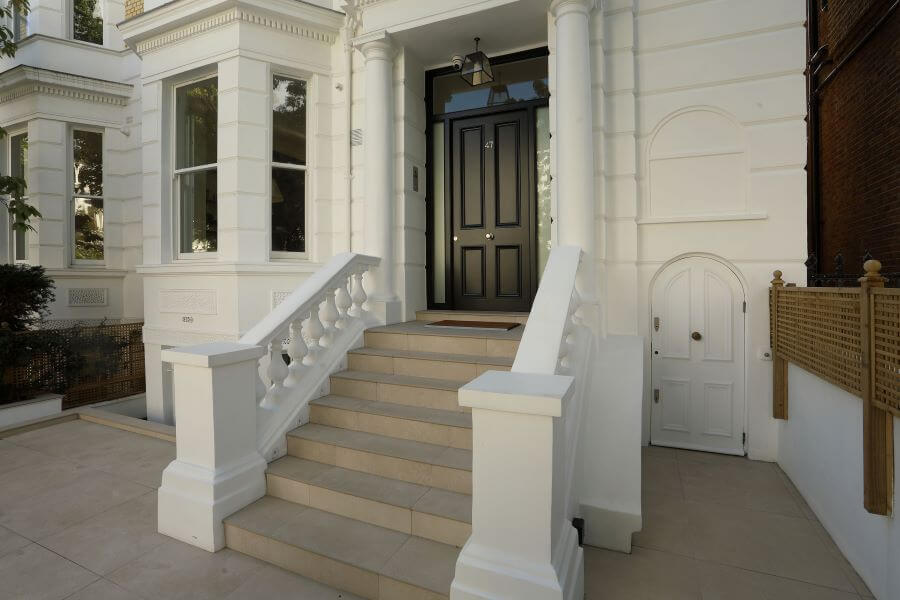 ITALIAN-INSIDE-OUTSIDE-PORCELAIN-TILES-8. Image shows beige tiles to steps of grand property