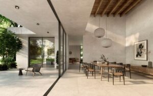 NEST-CONCRETE-EFFECT-TILE-BONE. Image shows concrete effect tile in cream colour in dining area and out onto the patio